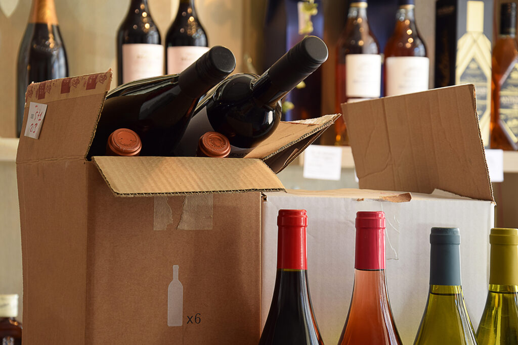 A box of wine and bottles are in the background.