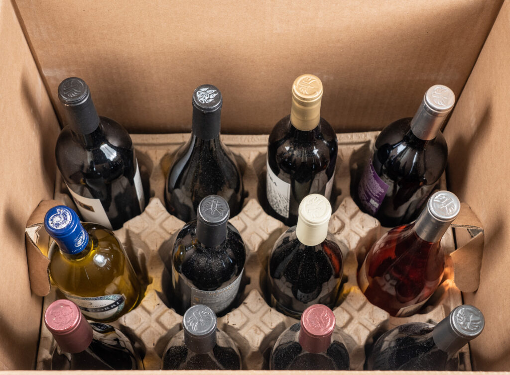 A box of wine bottles sitting on top of the floor.
