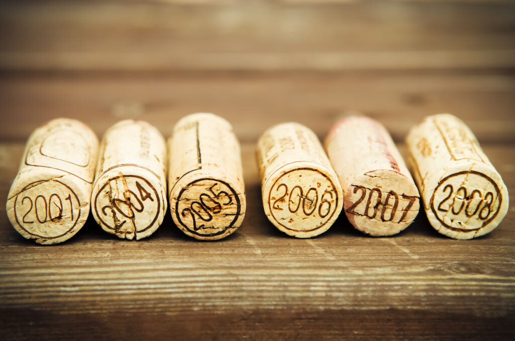 A row of wine corks with the year 2 0 0 3 written on them.