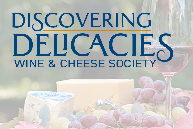 A bunch of grapes and cheese on the table