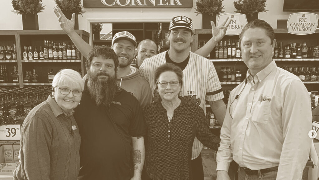 A group of people standing in front of a store.
