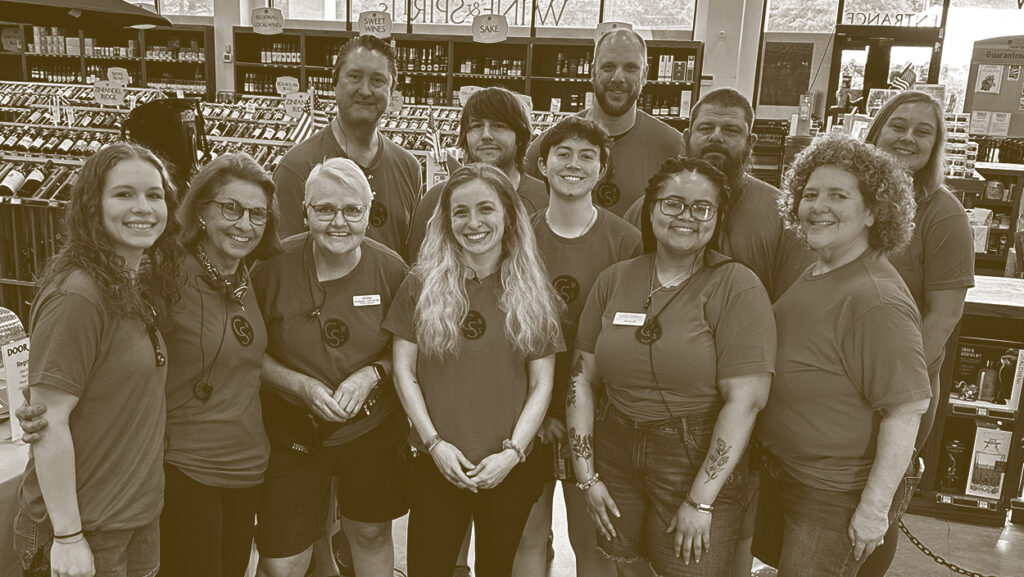 A group of people standing in front of shelves.